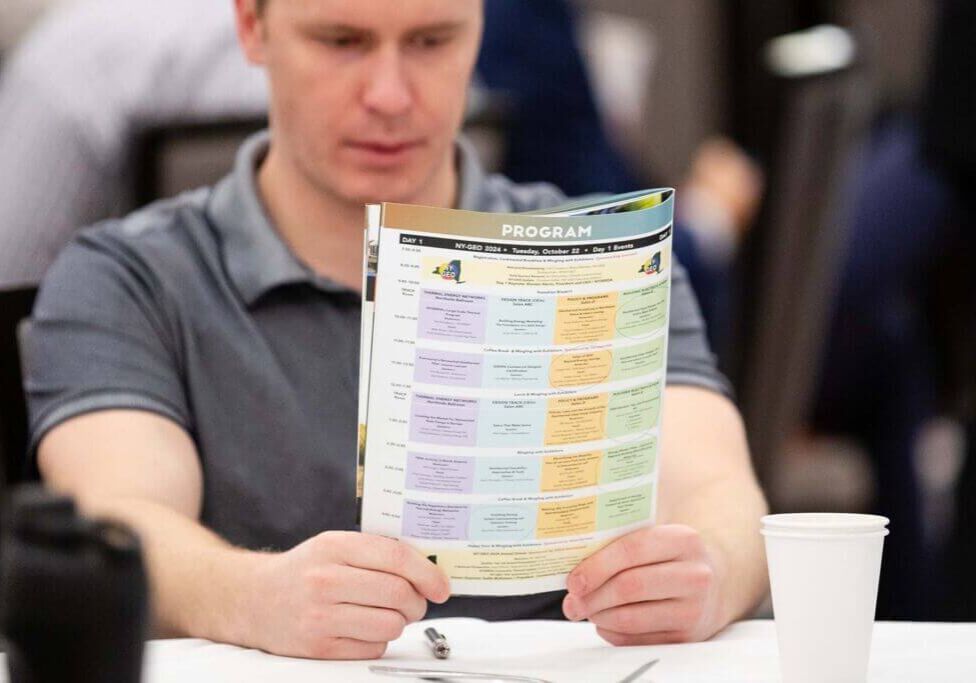 man reading event program